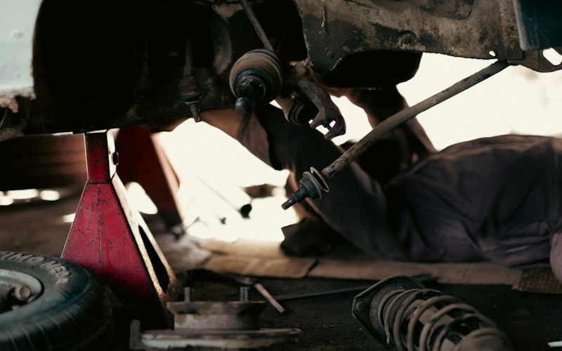 Mechanic working under a car